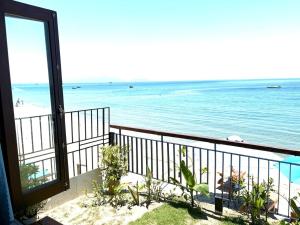 a view of the beach from a balcony at Hidden Beach Bungalow Sea View in Hoi An