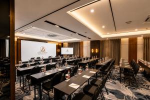 a conference room with tables and chairs and a screen at Arkadewi Boutique Hotel Prawirotaman in Yogyakarta +64 photos