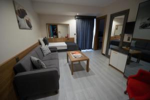 a living room with a couch and a table at Devin Otel in Isparta
