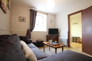a living room with a couch and a table at Chez lilles in Arette