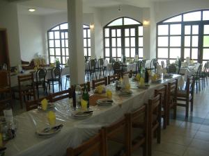 a dining room with a long table and chairs at Villa Meca in Međugorje
