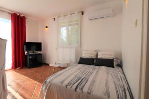 a bedroom with a bed and a television in it at Baserian in Saint-Pé-de-Léren +36 photos