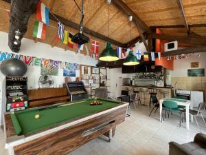 a billiard room with a pool table and a bar at Baserian in Saint-Pé-de-Léren