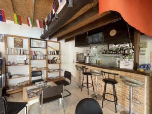 a bar in a restaurant with chairs and a counter at Baserian in Saint-Pé-de-Léren