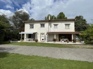 a large white house with a driveway at Baserian in Saint-Pé-de-Léren