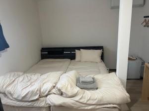 a large white bed with two towels on it at ビジネスホテルinn in Kashima