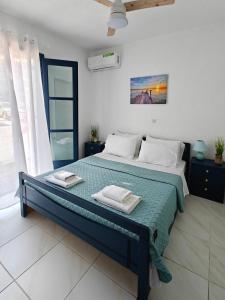 a bedroom with a bed with two towels on it at Brilliance Sea View Apartments in Ouranoupoli