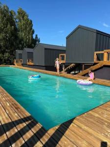two girls playing in the swimming pool of a tiny house at Marina Górkło - Żurawi Kąt in Górkło