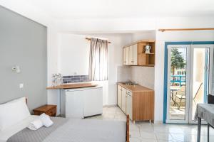 a bedroom with a bed and a kitchen with a table at Fiore Di Mare Studios in Lassi +71 photos