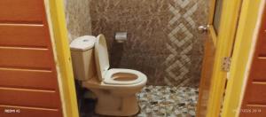 a bathroom with a toilet in a bathroom stall at Gotrika Valley Gesst in Ella