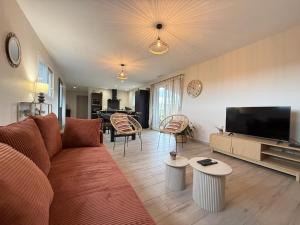 a living room with a couch and a flat screen tv at Eyhegaya in Ordiarp