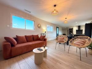 a living room with a couch and two chairs at Eyhegaya in Ordiarp