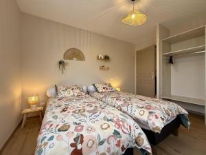 a bedroom with two beds and a television at Eyhegaya in Ordiarp
