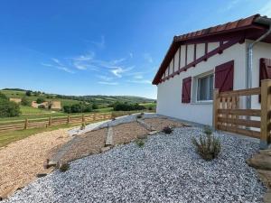 a house with a fence and a gravel yard at Eyhegaya in Ordiarp