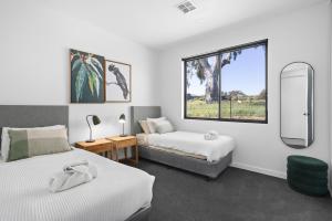 a bedroom with two beds and a window at Wild Wombat in Mansfield