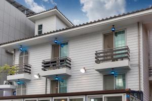 a building with balconies on the side of it at Daecheon gyeoulyeonga pension in Boryeong