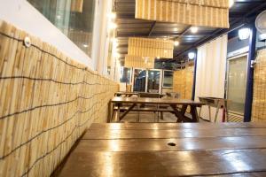 a restaurant with two wooden tables in a room at Daecheon gyeoulyeonga pension in Boryeong +13 photos
