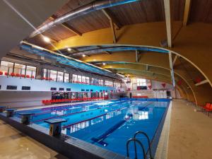 a large swimming pool in a large building at Miguičionių sodyba in Migučionys