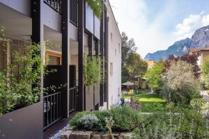 an apartment building with plants on the side of it at Locanda Restel De Fer in Riva del Garda