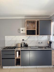 a kitchen with stainless steel appliances and a counter top at Cubes Ledig Luxury Apartments in Ledig