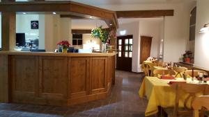 a restaurant with tables and chairs and a bar at Hotel Weberhof in Zittau