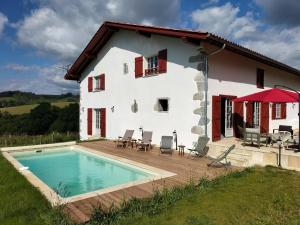 a house with a swimming pool in front of it at Artekoborda in Souraïde