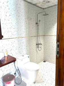 a bathroom with a toilet and a shower at Hidden Beach Bungalow Sea View in Hoi An