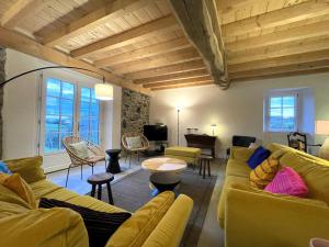 a living room with yellow couches and a piano at Artekoborda in Souraïde