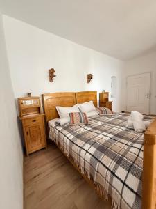 a bedroom with two beds with a plaid blanket at Pensiunea Belleview in Sibiu