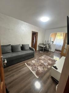 a living room with a couch and a table at Apartamente Giu in Giurgiu