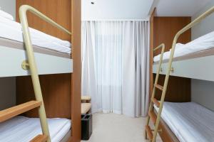 a room with two bunk beds and a window at Original Sokos Hotel Royal in Vaasa