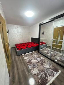 a room with a bed with red pillows on it at Apartamente Giu in Giurgiu
