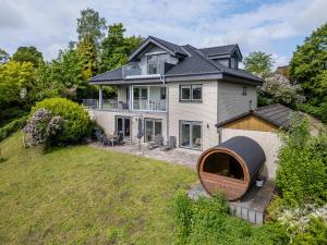 a house with a large yard with a wooden circle at Haus am See in Stocksee