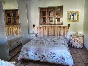 a bedroom with a bed and a mirror at Casa vacanze Felicitas in Martone