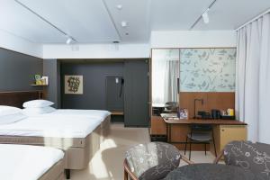 a hospital room with two beds and a desk at Original Sokos Hotel Royal in Vaasa