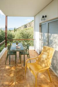 a patio with a table and chairs on a balcony at Panagea Holiday in Kitriaí