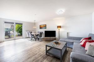 a living room with a couch and a table at Haus am See in Stocksee