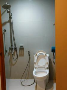 a bathroom with a shower and a toilet with the seat up at Nice Hotel Aurora Cubao in Manila +16 photos
