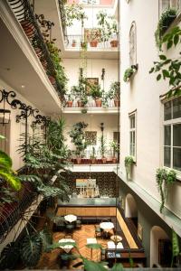 a room filled with lots of plants at Palais-Hotel Erzherzog Johann in Graz
