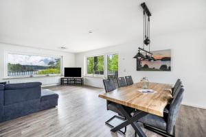 a living room with a dining table and a couch at Haus am See in Stocksee