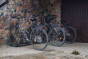 two bikes are parked next to a stone wall at Zaczarowany Gaj in Gaj Grzmięca +4 photos