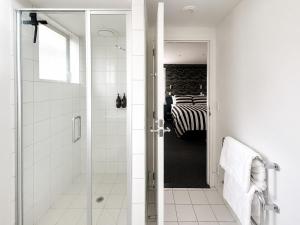 a bathroom with a shower and a walk in shower at Cathedral Junction Apartments in Christchurch +20 photos