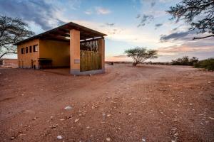 a small building in the middle of a dirt road at Namib Desert Campsite in Solitaire