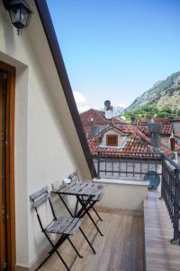 two chairs sitting on the balcony of a building at Step to Kotor Bay Old Town in Kotor
