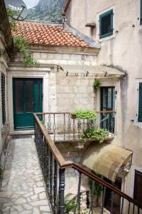 a stairway leading to a building with a green door at Step to Kotor Bay Old Town in Kotor