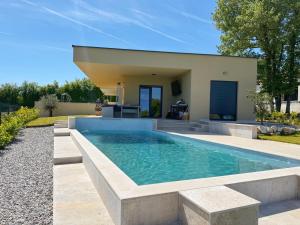 a swimming pool in the backyard of a house at Villa Nella in Tinjan