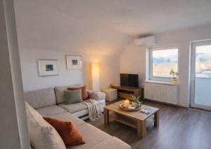 a living room with a couch and a table at Apartment Čebelica in Lesce