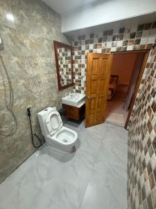 a bathroom with a toilet and a sink at Banana villa in Rasdhoo