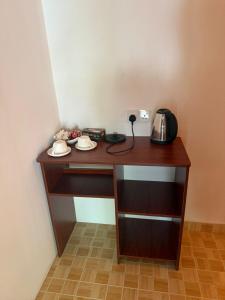 a wooden desk with a telephone on top of it at Banana villa in Rasdhoo