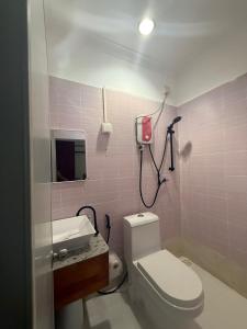 a bathroom with a toilet and a sink and a mirror at Banana villa in Rasdhoo